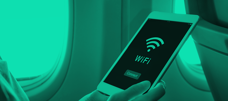 a hand of a person holding a phone using wifi on a plane