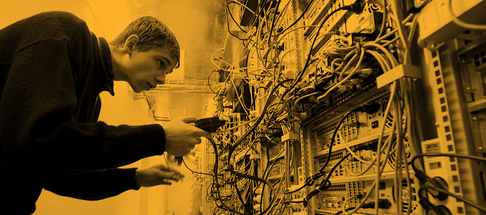 young man trying to block connection in a server room