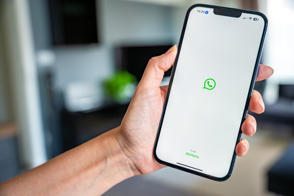 woman holding iphone whatsapp on the screen